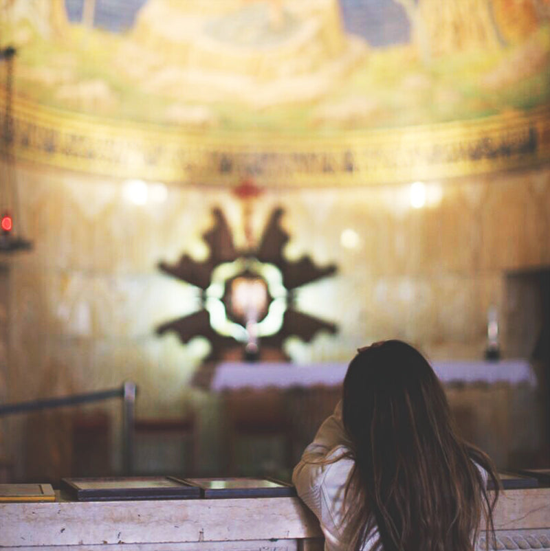 young girl kneeling at an altar railing glowing altar paintings