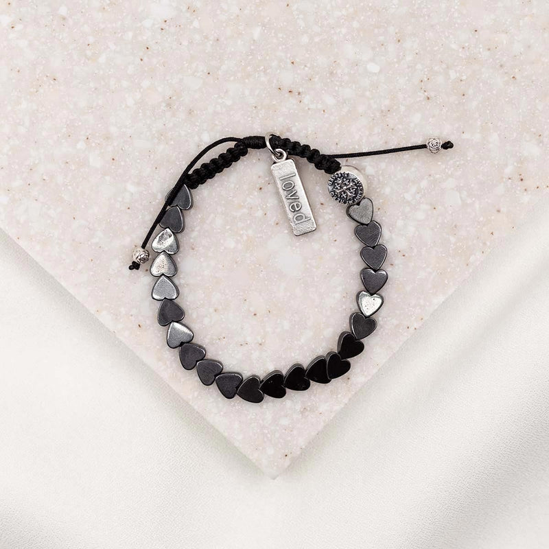 hematite heart bracelet with silver loved charm and my saint my hero bead