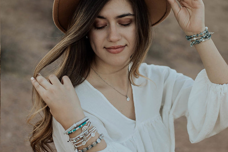 girl in desert wearing a hat and my saint my hero wearable blessings jewelry collections
