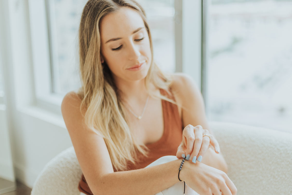 Woman praying on the St. Ignatius of Loyola Spiritual Awakening Bracelet