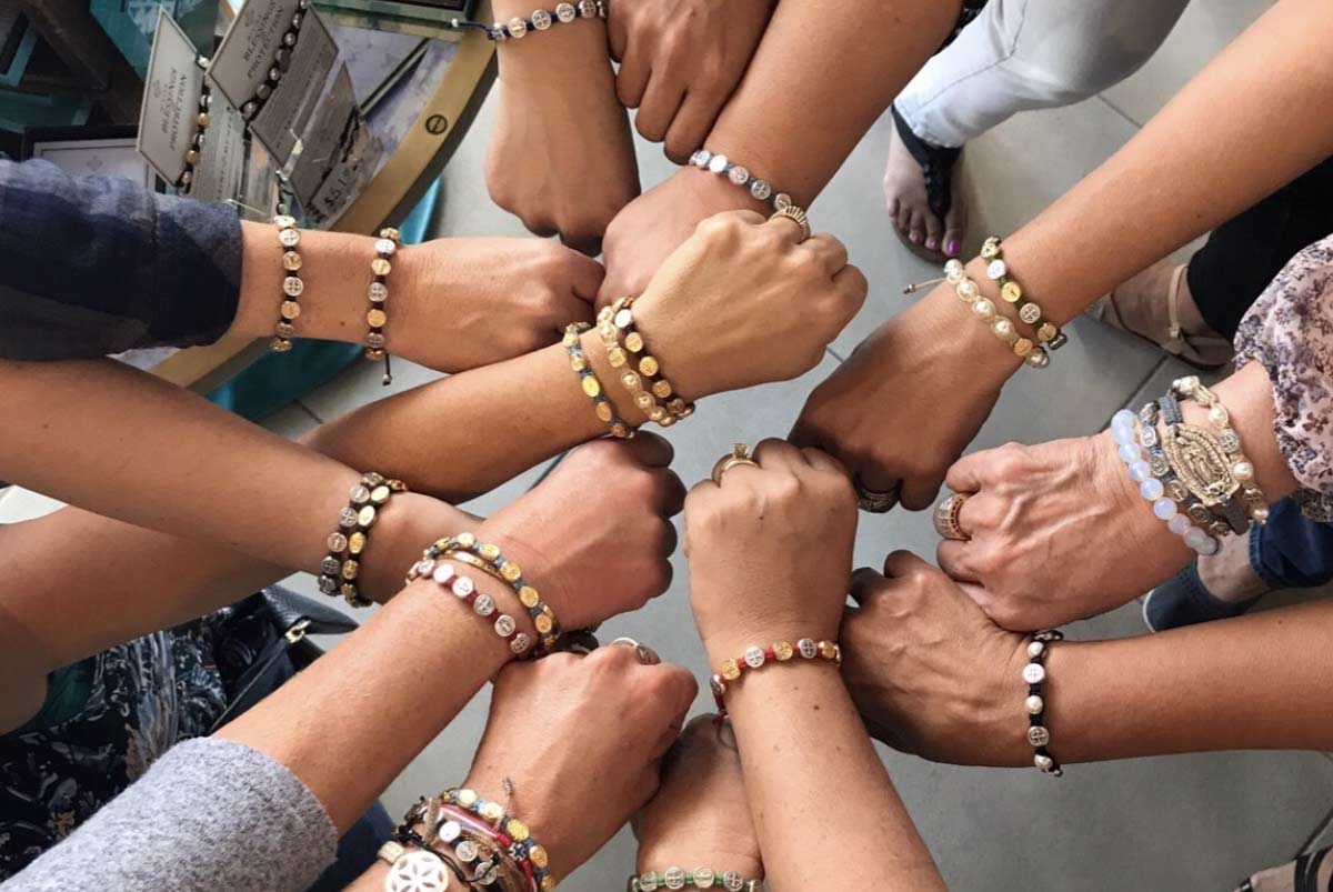 Mom holding a Blessing Bracelet as a gift for sending her child off to college