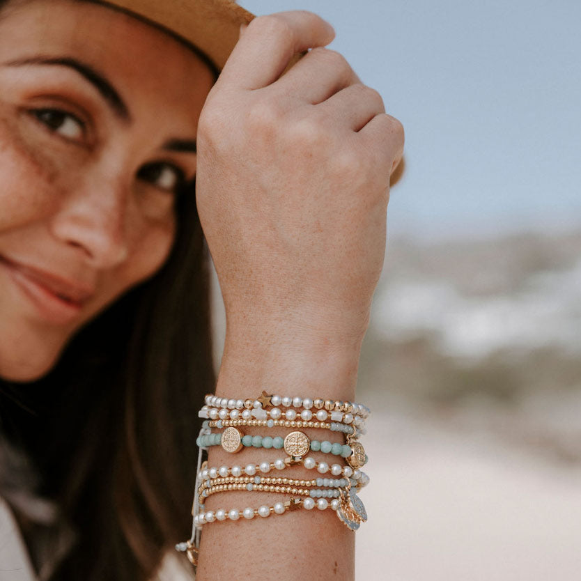 Catilin Stamos wearing a stack of My Saint My Hero Beaded Blessing Bracelets