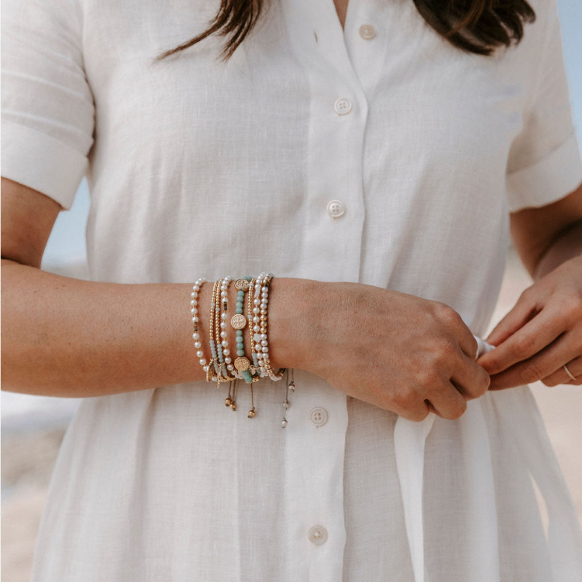 Catilin Stamos wearing a stack of My Saint My Hero Beaded Blessing Bracelets