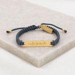 Nada te Turbe Bracelet with gold tone medals and slate woven cording