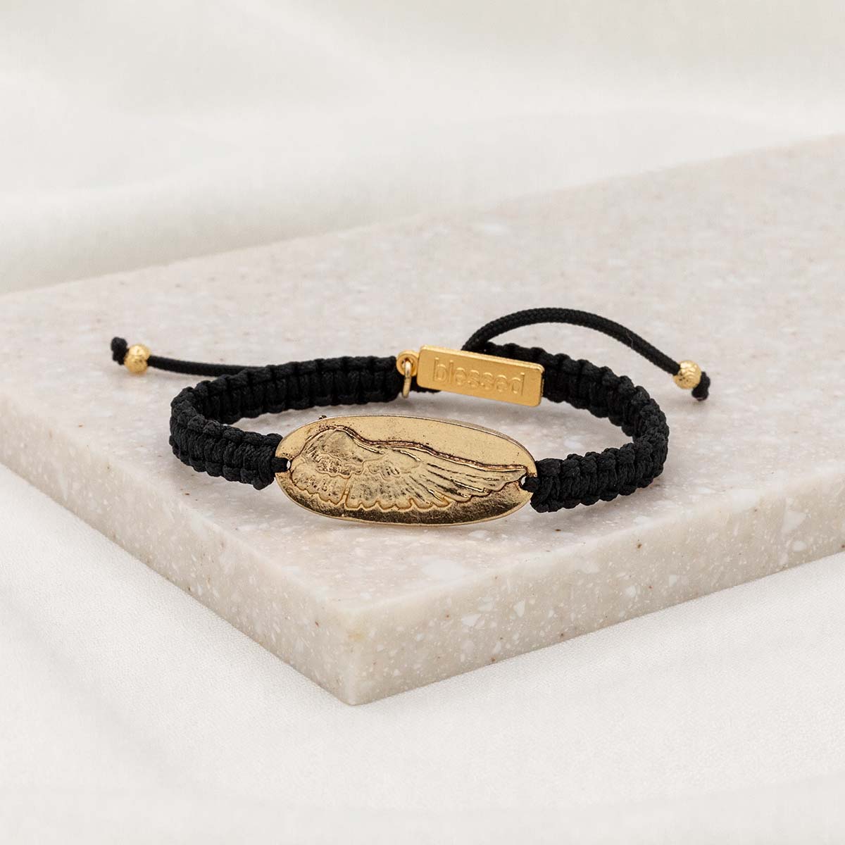 Wing of Protection black woven cording bracelet with gold angel wing medal