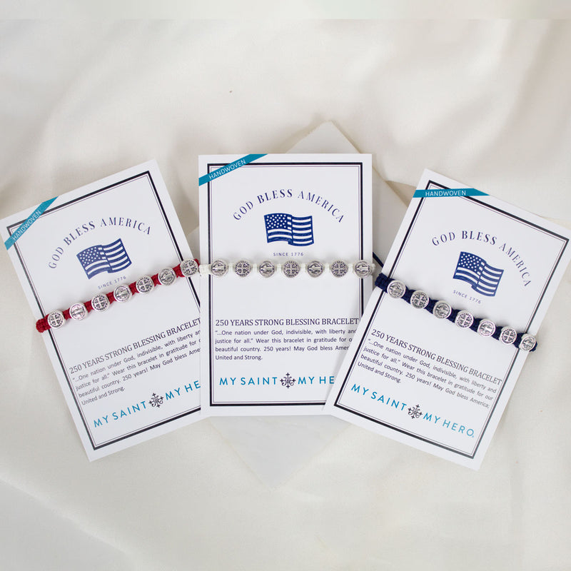 Three 'God Bless America' bracelets with cards on a white background
