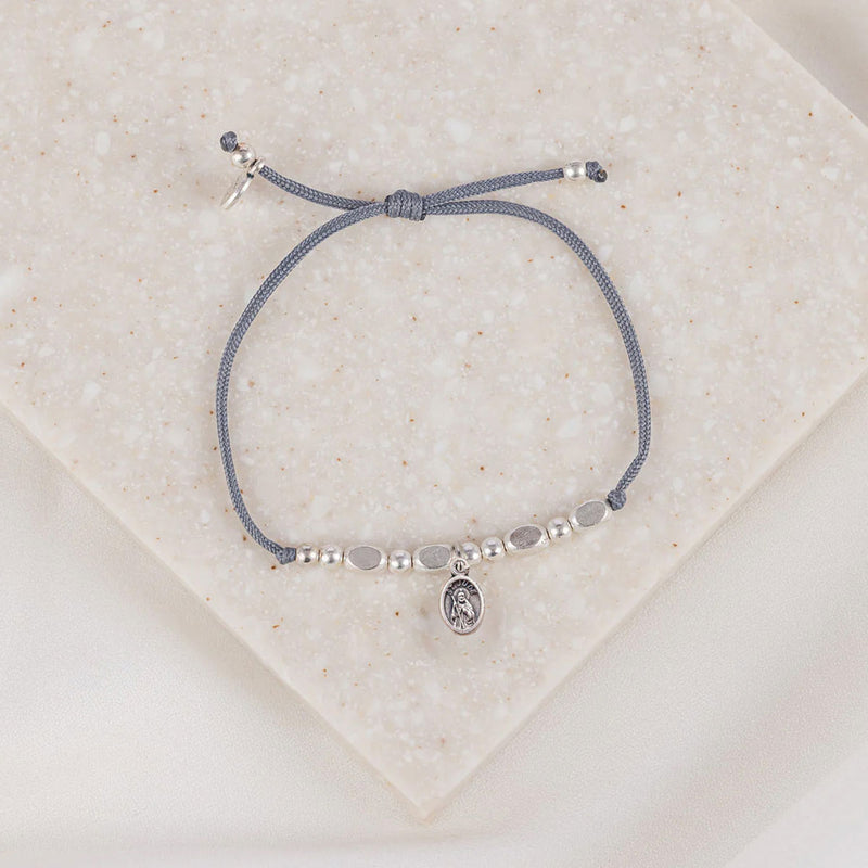 The Little Saints Saint Jude Silver Beaded Bracelet with gray cording and slipknot closure