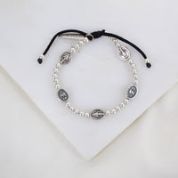 Held by Mary Silver Beads and Miraculous Mary Medal bracelet on black woven cording