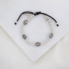 Held by Mary Silver Beads and Miraculous Mary Medal bracelet on black woven cording