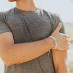 Man wearing Blessing for a Cure for Him tan woven Benedictine Bracelet 