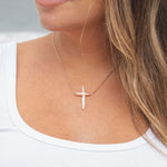 close up of a woman wearing a vermeil gold and natural pearl cross Abide Pearl Cross Necklace