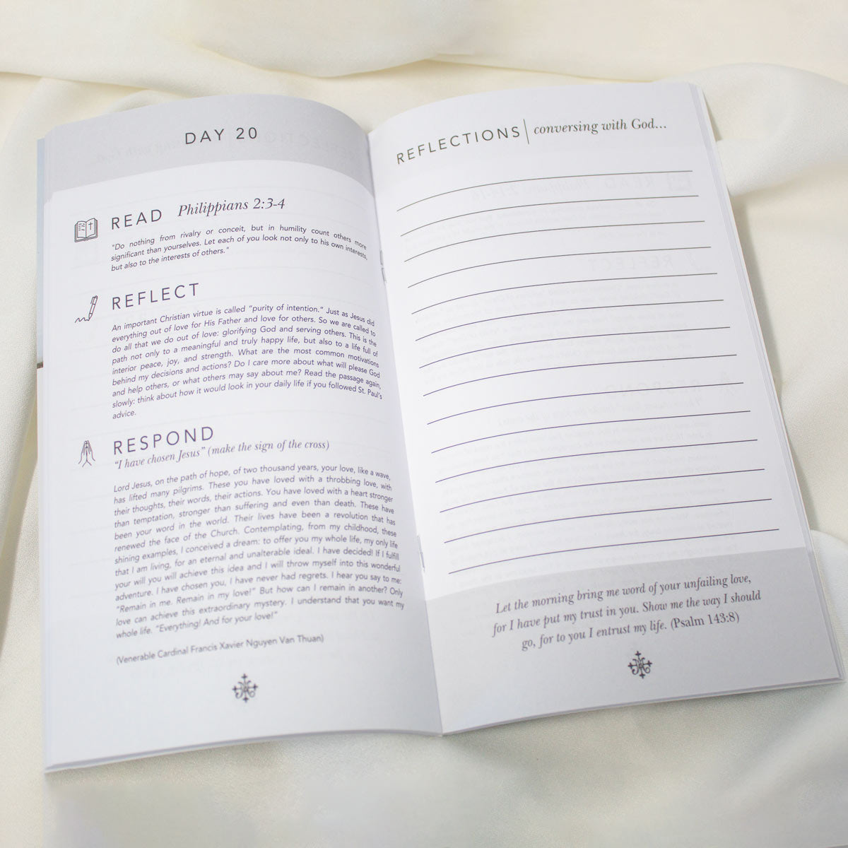 An open 40 Day Prayer Pledge Booklet showing Day 20 with reflection prompts and lined writing space, photographed on a soft white fabric background.