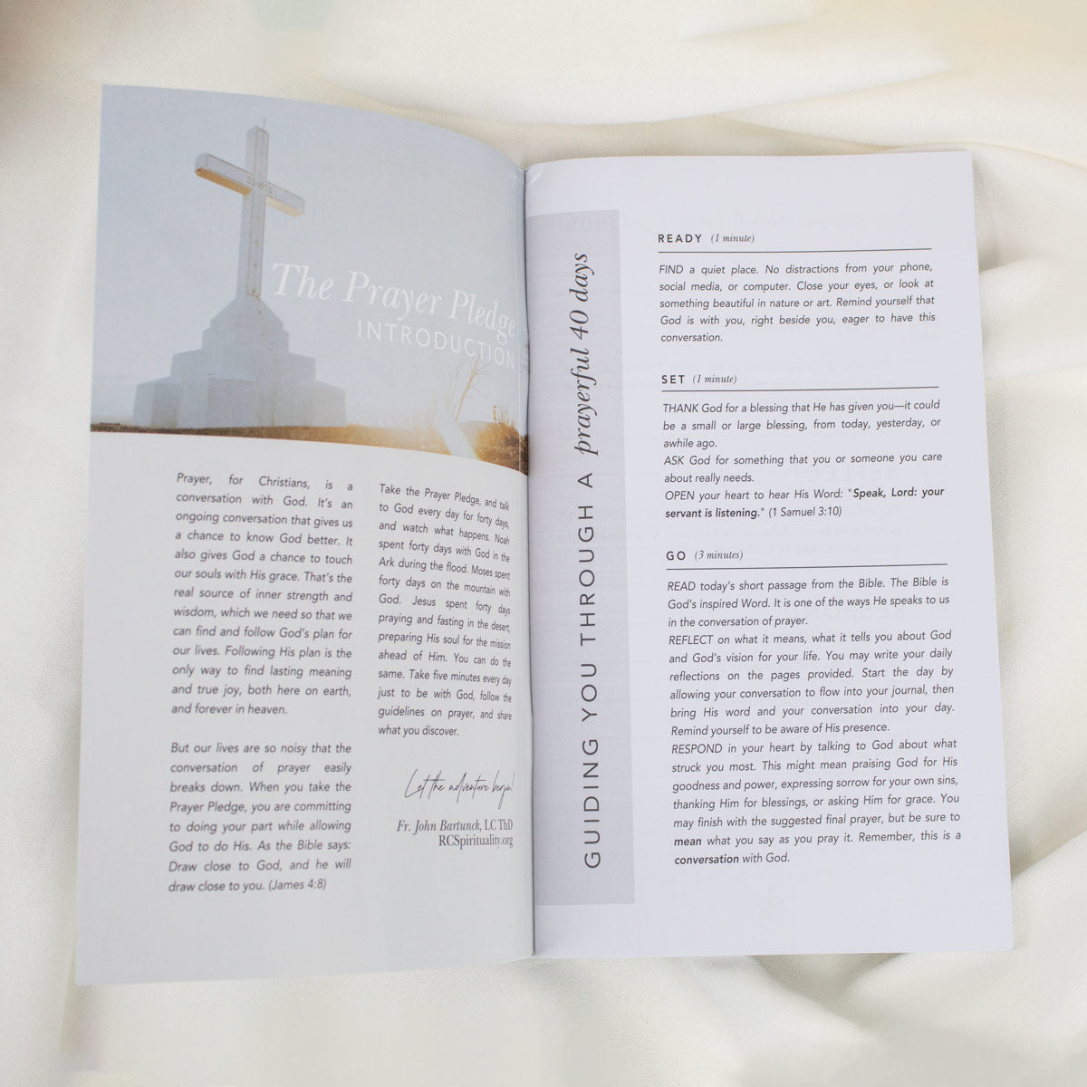 An open 40 Day Prayer Pledge booklet showing the left-hand page with a printed prayer header and text, and the right-hand page with a short devotional reading titled 'Guiding You Through a Powerful 40 Days.' 