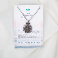 Necklace with decorative pendant on a 'My Saint My Hero' card with text
