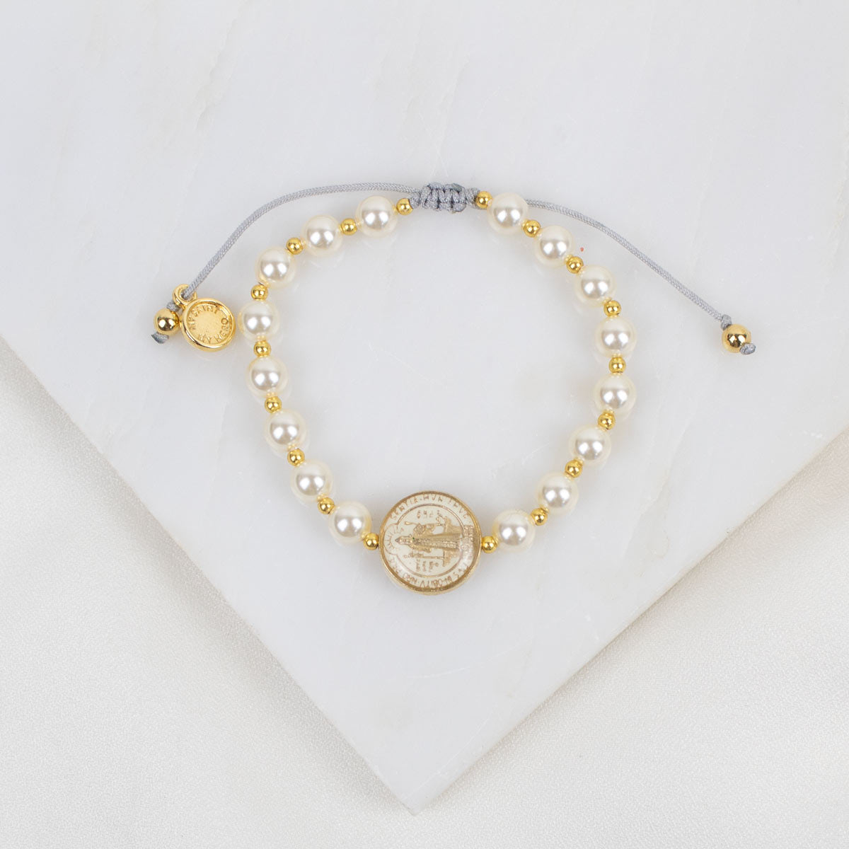 Pearl and gold beaded necklace on a white background