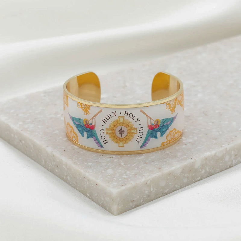 Decorative cuff bracelet with religious design on a marble surface