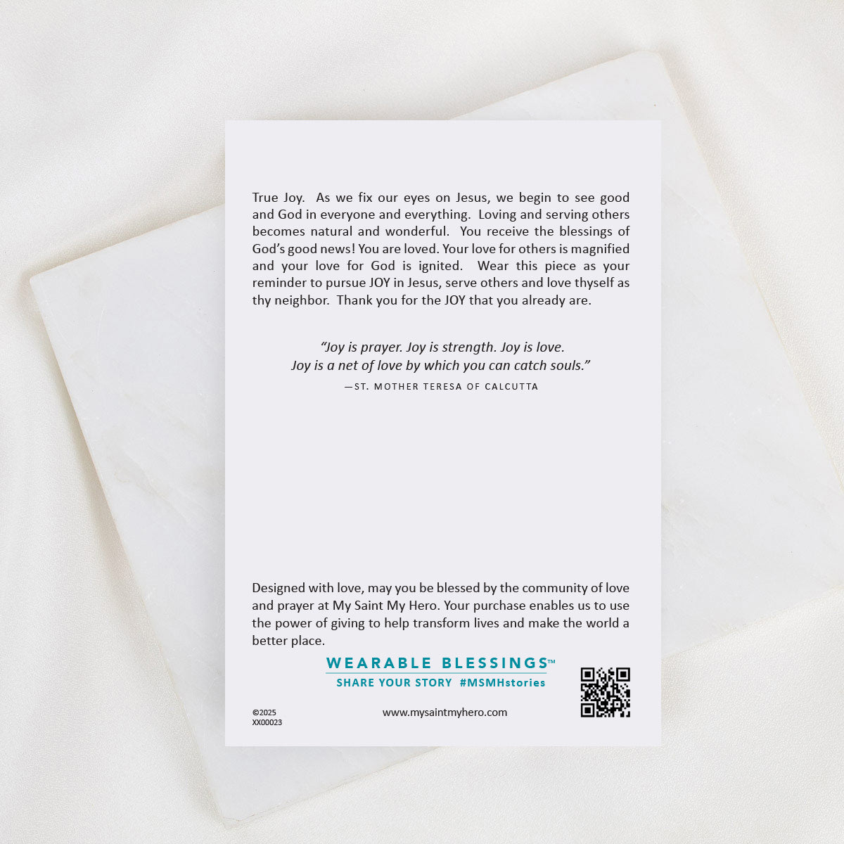 A white rectangular card with printed inspirational text and a QR code, photographed on a light marble surface with a white satin ribbon draped across the top. The card appears to be the product being sold rather than an auxiliary chart or instruction.