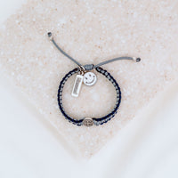 Kids Benedictine navy slate thread handwoven blessing bracelet with silver tone blessed charm and white enamel happy face