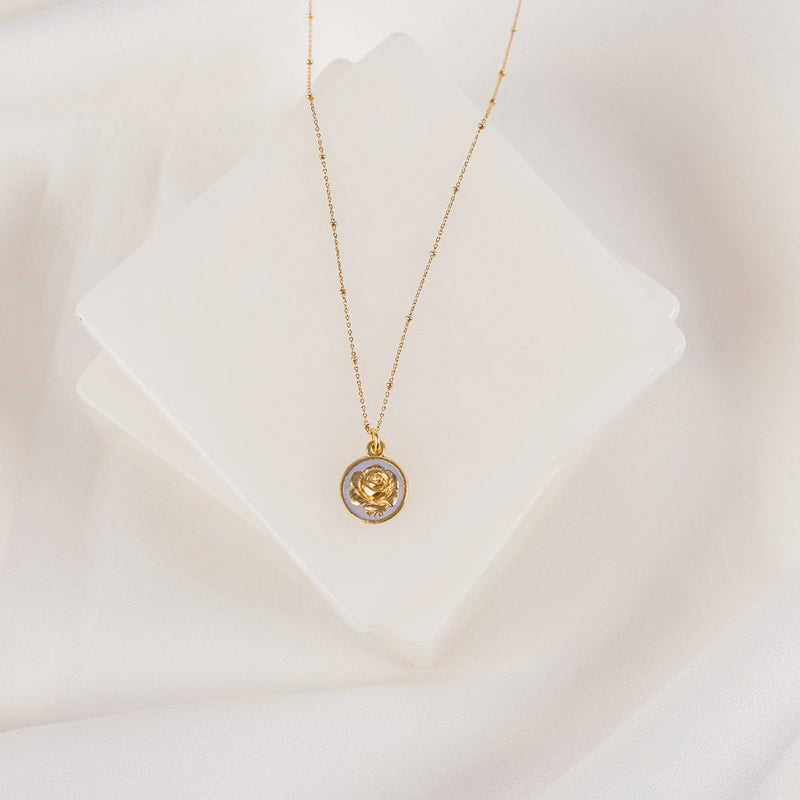 gold tone necklace with a rose and lavender enamel pendant