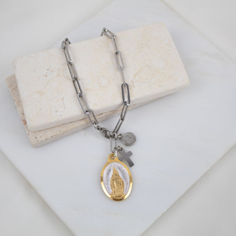 Lourdes Miraculous Mary Bracelet with a religious charm on a marble surface