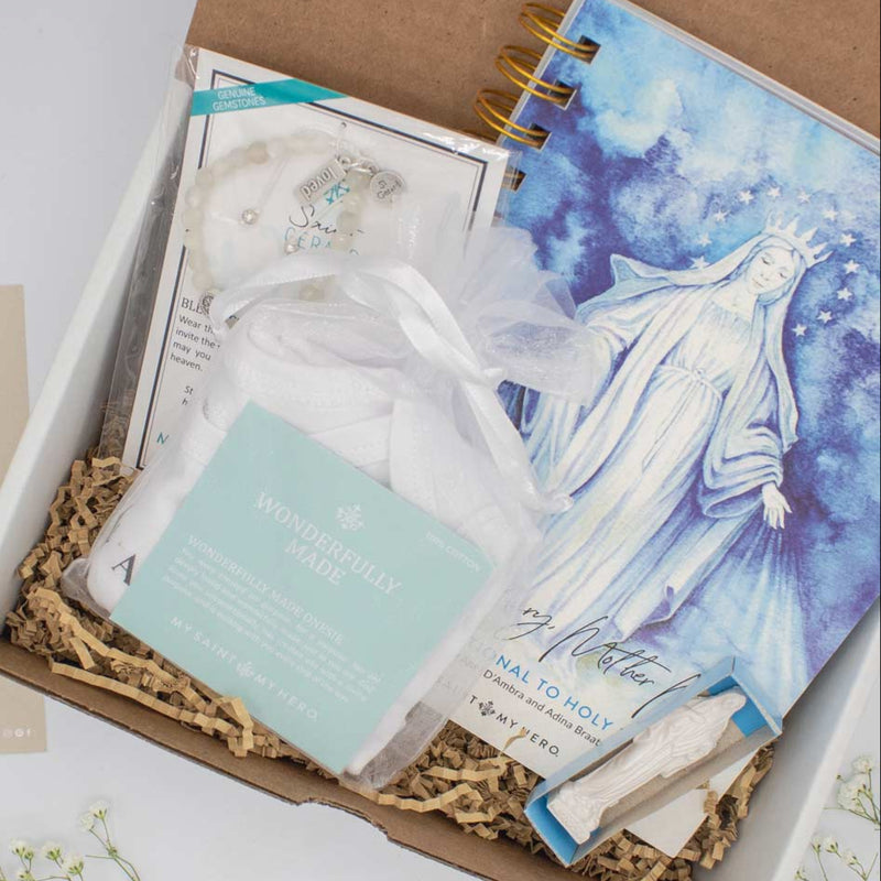 This limited-edition bundle includes St. Gerard Blessings for a Healthy Pregnancy Bracelet, Wonderfully Made Onesie, Mother Mary, Mother Me Devotional Journal and a Petite Mary Statue, and an inspirational card with A Mother's Blessing Prayer in a gifting box. Co-Authors Amy D'Ambra and Adina Braatz