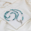 Rosary Wrap Bracelet with white, blue, and gray crystals and silver tone crucifix, Miraculous Mary medal and Benedictine medal