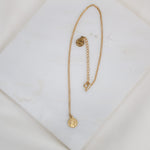 petite St. Francis Gratitude Necklace in gold with two inch extneder and "blessed" logo bug medal