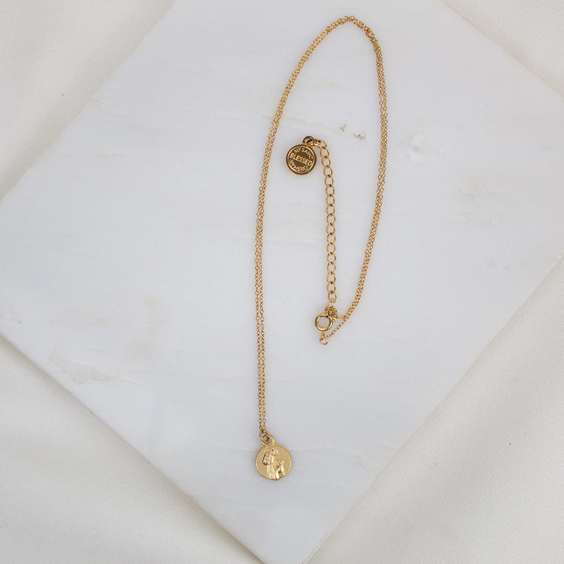 petite St. Francis Gratitude Necklace in gold with two inch extneder and "blessed" logo bug medal