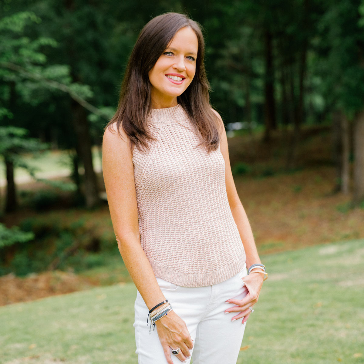 Woman wearing a stack of Wonderfully Made cross handwoven bracelets