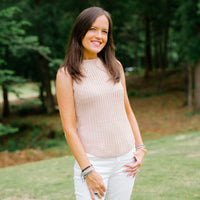 Woman wearing a stack of Wonderfully Made cross handwoven bracelets