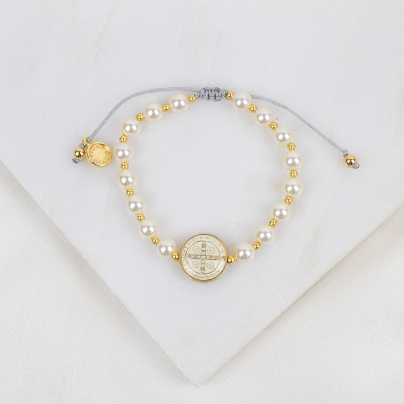 Pearl and gold necklace on a white background