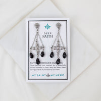 Pair of chandelier earrings on a 'My Saint My Hero' card with a white background