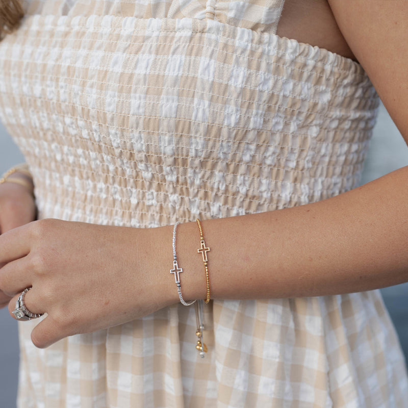 Filled by Faith Bracelets in silver and gold and a woman's wrist