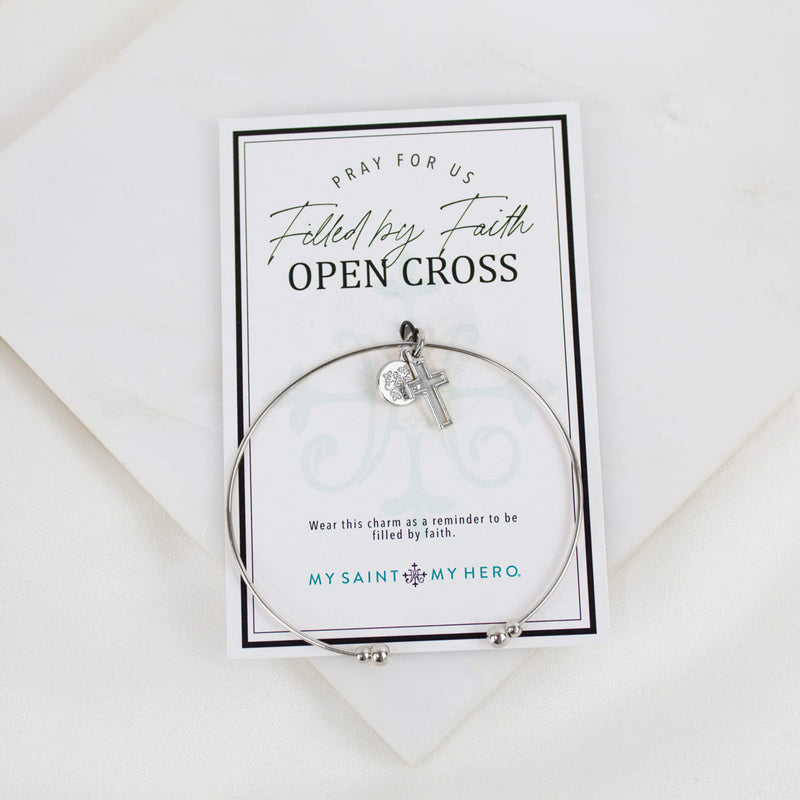 Silver-tone Filled by Faith Cross Whisper Bangle Cuff bracelet displayed on its inspirational open cross product card.