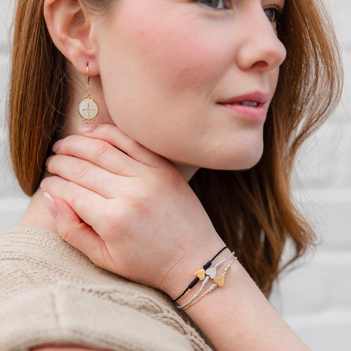 Young woman wearing the three versions of the petite heart and corded bracelets