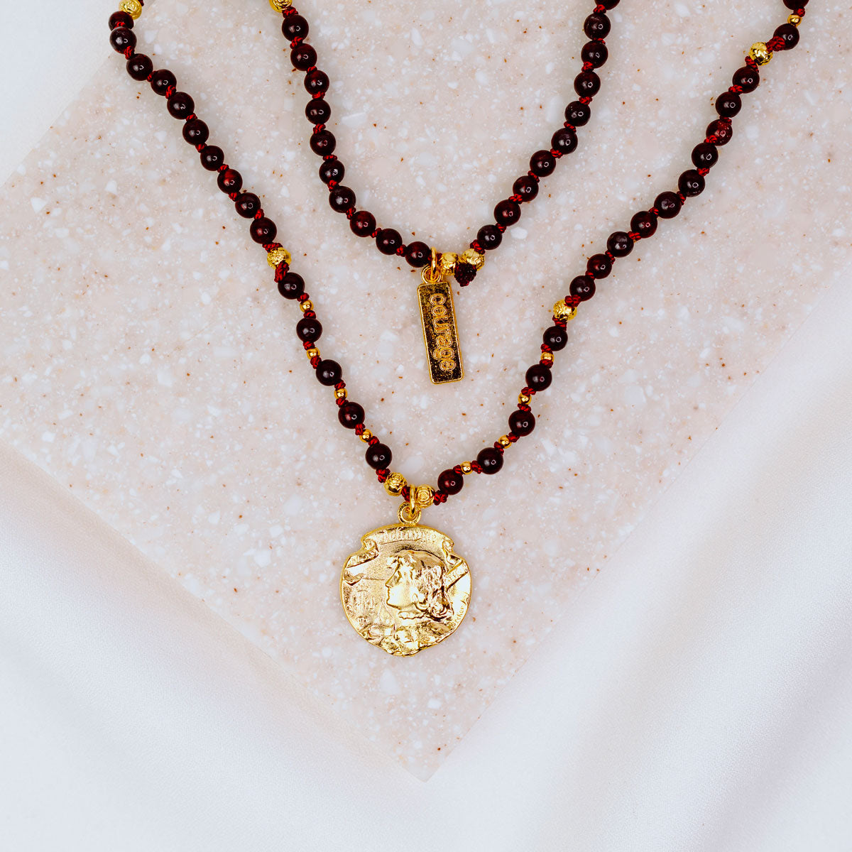 Gold Joan of arc medal on a handbeaded gemstone necklace