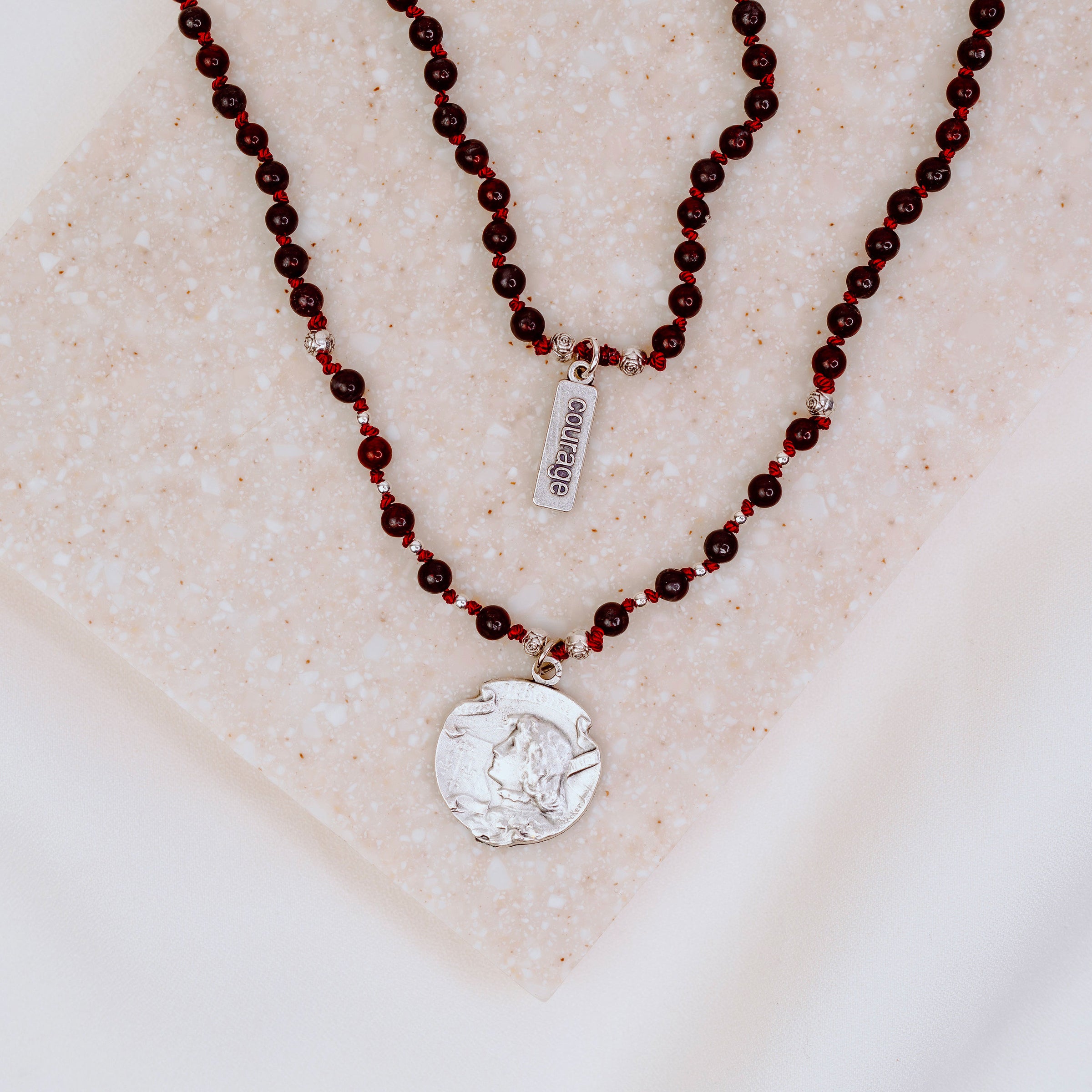 Silver Joan of arc medal on a handbeaded gemstone necklace