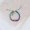 Kids Benedictine rainbow thread handwoven blessing bracelet with silver tone blessed charm and white enamel happy face