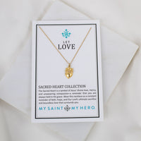 Gold necklace with a heart pendant on a card with text and branding