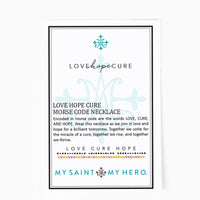 A square product card for the Love Hope Cure Morse Code Necklace, featuring a white background with black text, a light blue ornamental design, and a small multicolor dotted row. The card is branded 'MY SAINT MY HERO.