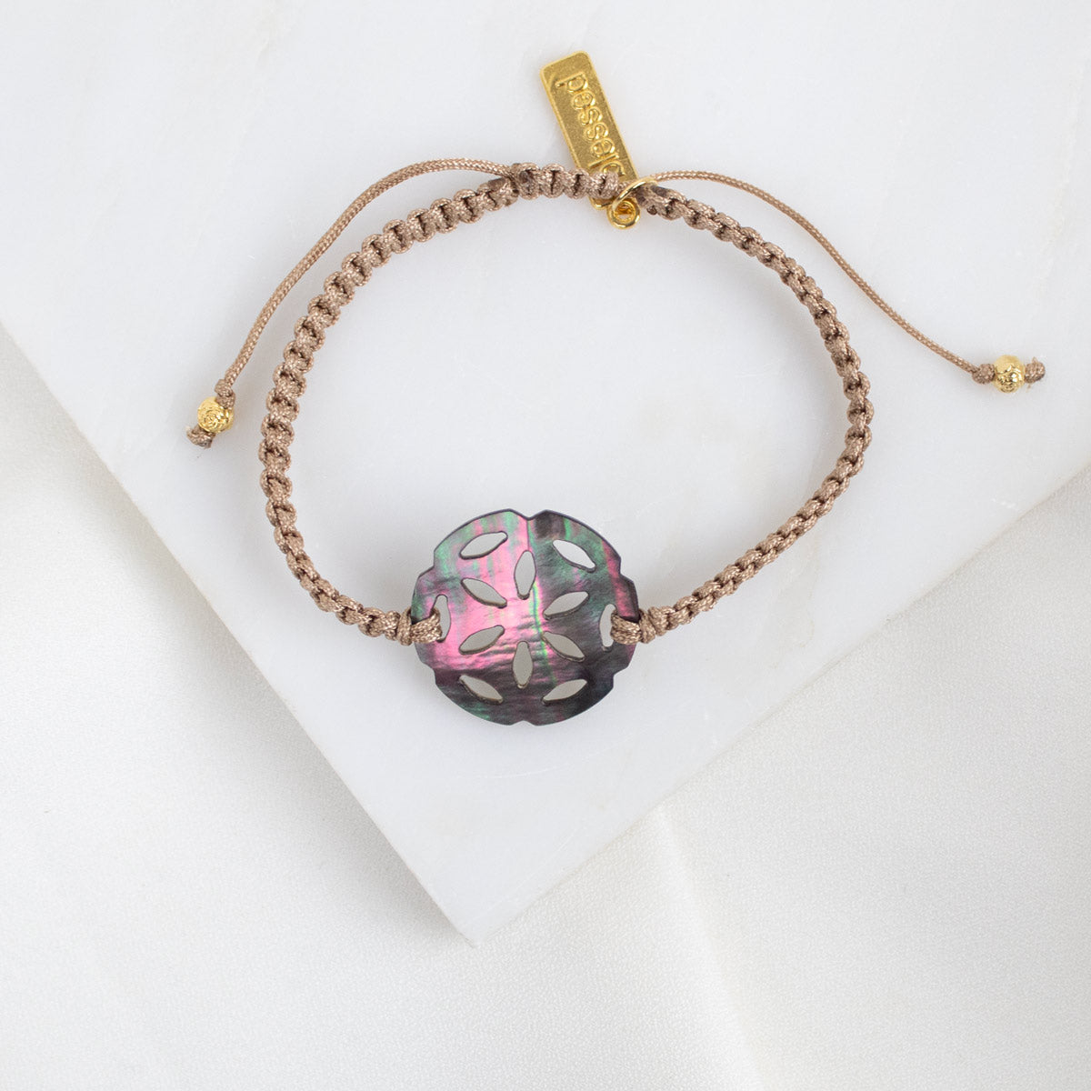Bracelet with a mother of pearl rosette on a white background