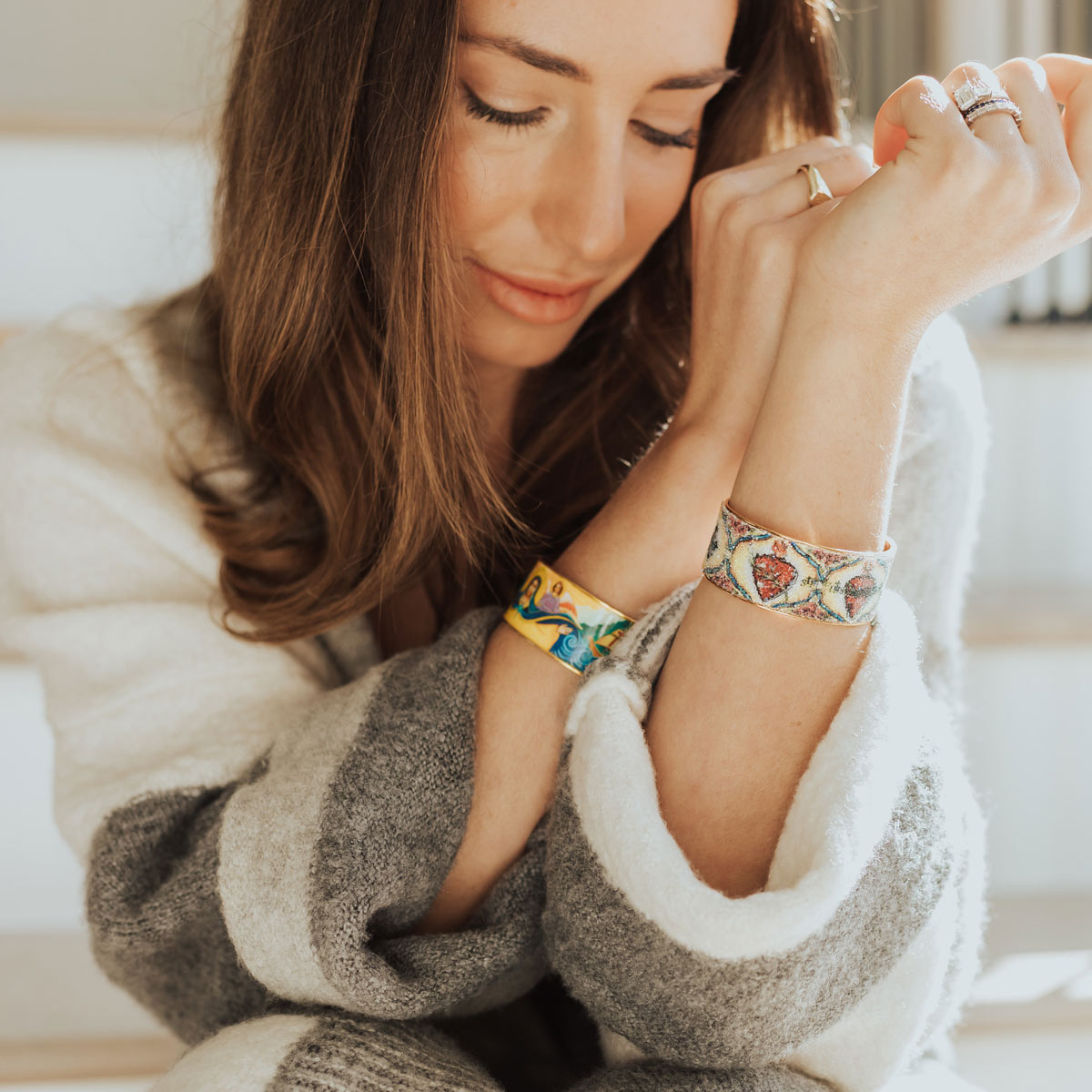 Woman wearing the My Saint My Hero Mary Star of the Sea gold-tone cuff bracelet with a colorful sacred Marian icon.