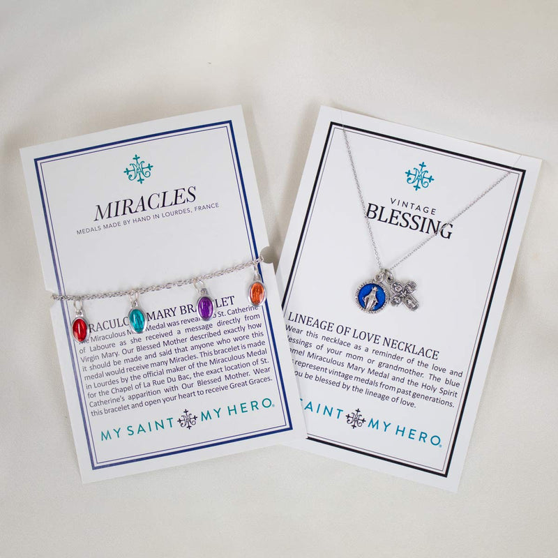 Two necklaces on cards with 'Miracles' and 'Vintage Blessing' text, featuring colorful beads and a cross.