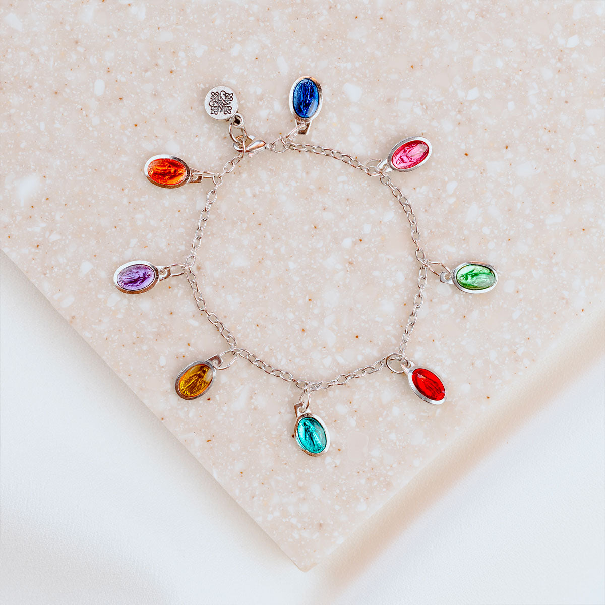 Brightly colored charm bracelet with enamel Miraculous Mary petite medals on silver tone chain