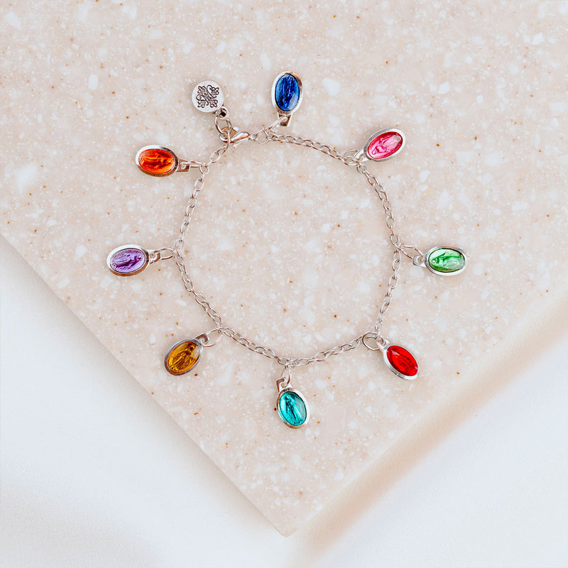 Brightly colored charm bracelet with enamel Miraculous Mary petite medals on silver tone chain