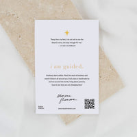 Card with inspirational quote and QR code on a textured surface
