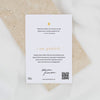 Card with inspirational quote and QR code on a textured surface
