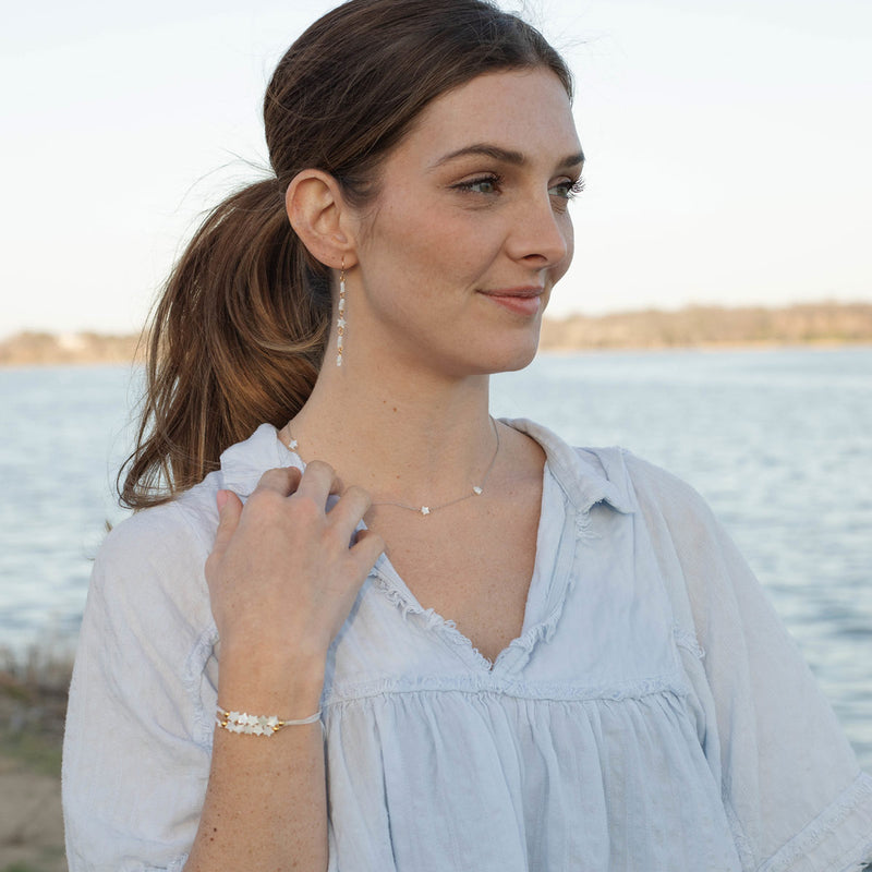 North Star Mother of Pearl Star Bracelets worn with matching earrings and necklace