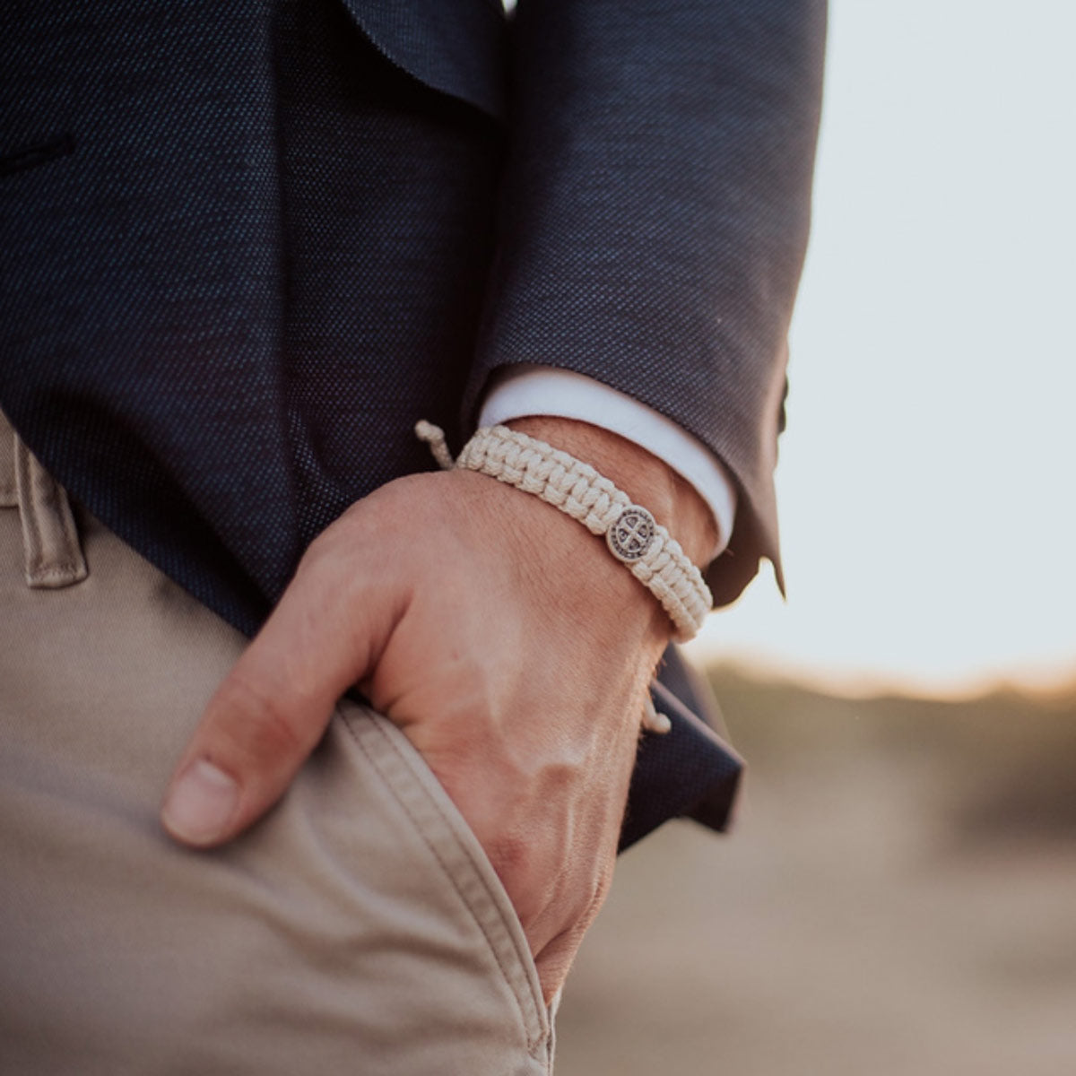 close up of a man's wrist wearing a One Blessing for Him St. Benedict medal bracelet