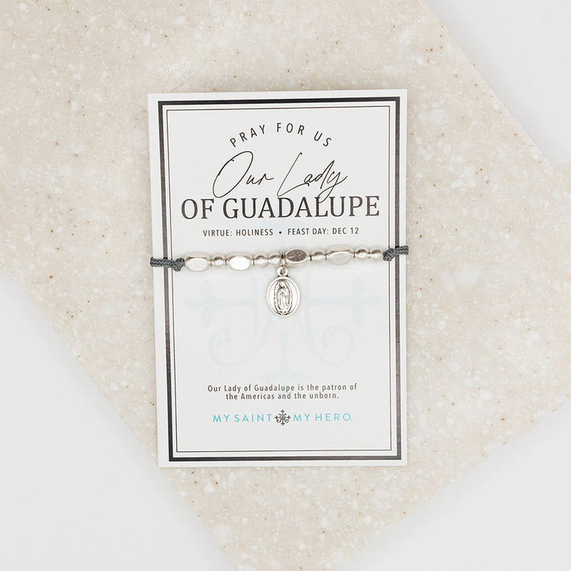 Adjustable slate grey bracelet with silver-tone metal beads and a double-sided Our Lady of Guadalupe/Divine Mercy medal, presented on an inspirational card.